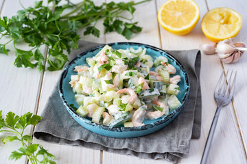 Spicy salad with shrimp and vegetables on a white background.