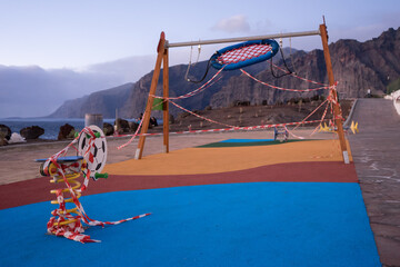 Closeup shot with playground wrapped in barricade tapes
