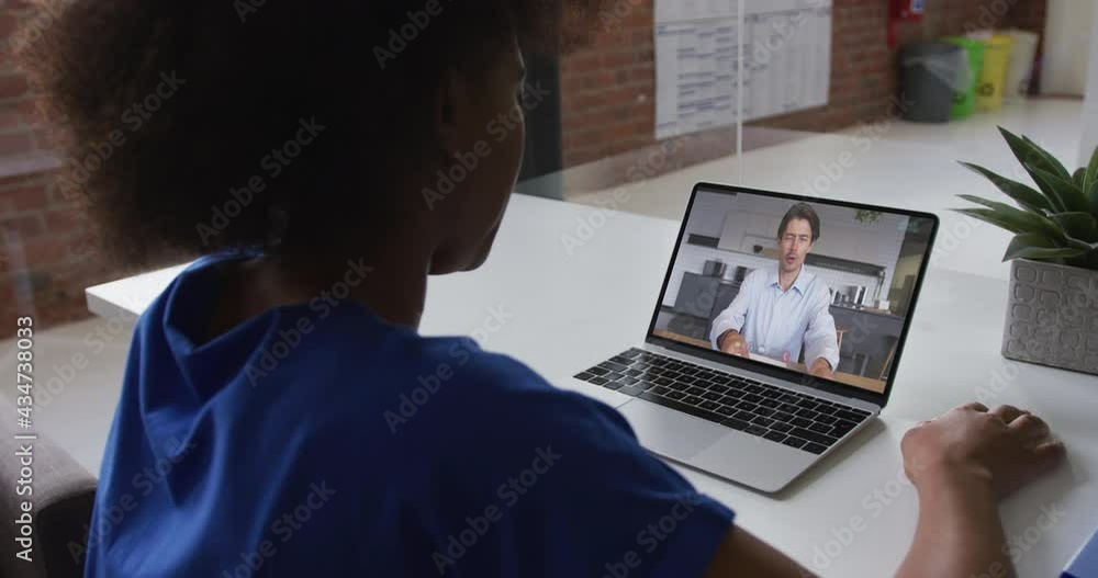 Sticker African american woman talking on video call with male colleague on laptop at office