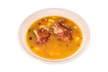A plate of pea soup with smoked pork on a white background top view.Pea soup with smoked ribs.