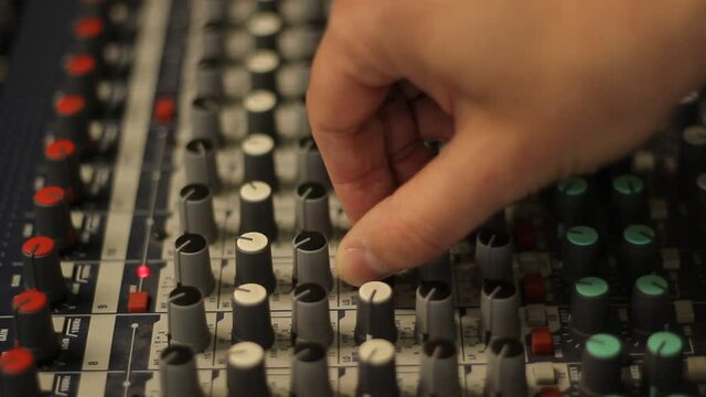 Audio mixer fader operating. Balancing volume of audio inputs of analog audio mixer.