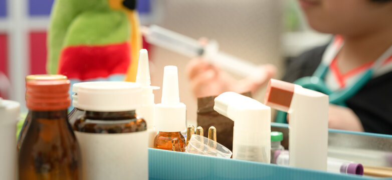 Variety of medicine package on tacle includes bottle spray MDI syrup on blur background
