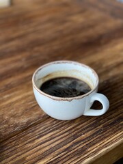 cup of coffee on wooden table
