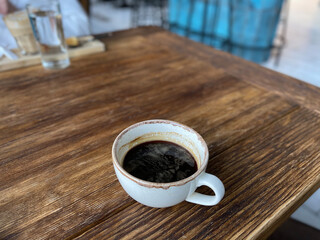 cup of coffee on wooden table