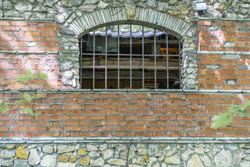 Embossed textured surface of an old wall made of facade bricks and cement