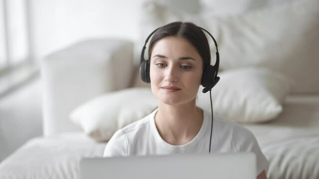 Woman in headset web cam consultant talking blogger happy online teather