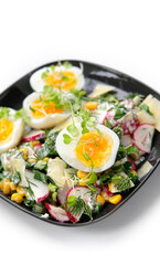 Fresh spring salad close up. green leaves salad, eggs, radish, onion, cucumber, corn, micro greens, parmesan. Healthy food