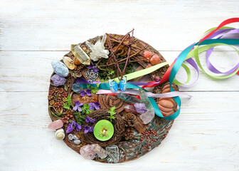 Wiccan altar for Beltane sabbath. spring pagan festive ritual. wheel of the year with ribbons,...