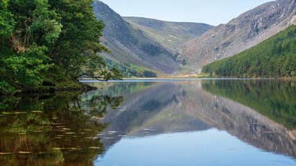 Reflections in the Glendalough Upper Lake water in Wicklow Mountains, Ireland.