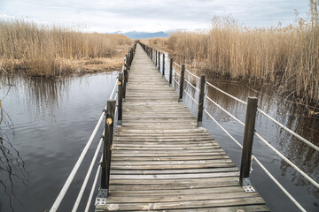 A wooden footbridge leading through marshes and lakes inside the Central Anatolian Sultan Reedy (Sultansazligi) National Park, Turkey