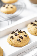 Delicious Whole Wheat Chocolate Chip Cookies set on white cafe table.