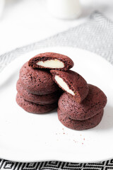 crunchy red velvet cookies set on white cafe table.