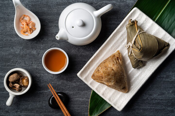 Zongzi. Rice dumpling top view for Dragon Boat Festival over dark black background.