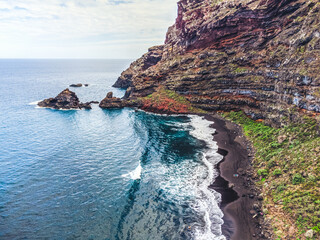 Rocky, volcanic beach and unsettled atlantic ocean. La Palma Island. Aerial view.