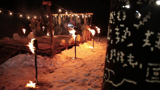 Black barrel that glows with ancient viking rune symbols. Night, low light. Behind the ring, a pedestal for fighting between opponents, ritual place of ancient vikings with torches, fire
