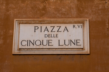 Street sign in the historical center in Rome, Italy, with the text: "Piazza delle Cinque Lune"