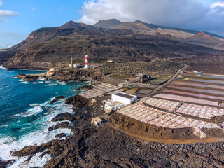 Volcanic landscape with lighthouse and salt production facility. La Palma island, aerial view.