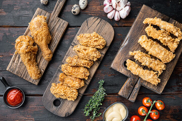 Crispy fried chicken on old dark wooden table, flat lay