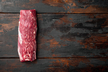 Tenderloin, or Eye Fillet cut raw marbled beef meat, on old dark  wooden table background, top view...