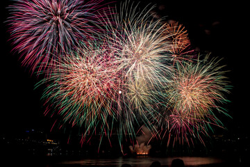 Large fireworks display over Parliament with the full moon in the middle, Ottawa, Ontario, Canada