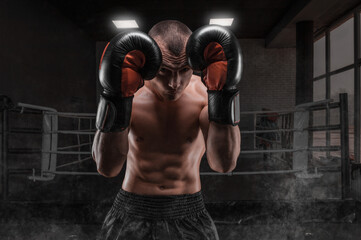 Image of a boxer in the gym. He covers his head with gloves. Protective rack. Mixed martial arts.