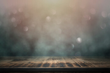 Empty wooden table with smoke float up on abstract blurred bokeh lights background, used as a...
