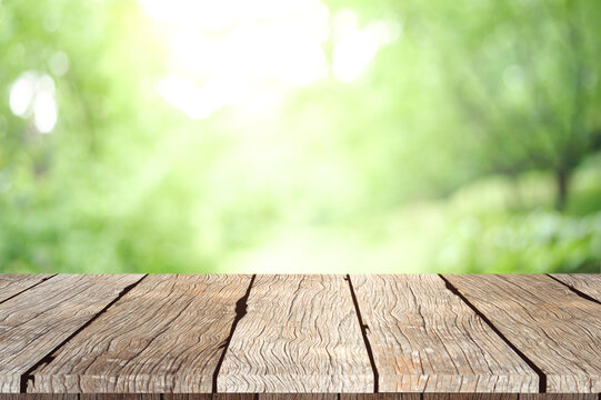 Empty wooden table with garden bokeh background with a country outdoor theme, Template mock up for display of product