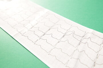 Cardiogram close-up on green background. Heart diagnosis concept
