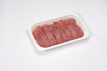 raw pork tenderloin on a white tray