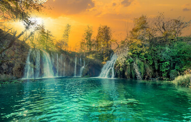 Panorama of the most beautiful places in Europe, Plitvice area of Croatia with emerald turquoise lakes and natural waterfalls illuminated at sunset
