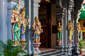 Colourful statues of Hindu religious deities adorning the interior of a Hindu temple in Singapore.