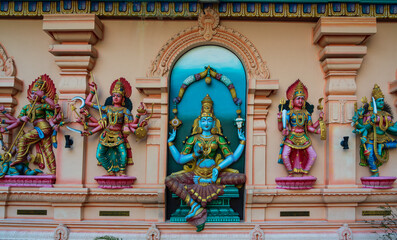 Colourful statues of Hindu religious deities adorning the interior of a Hindu temple in Singapore.