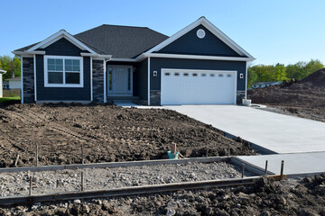 New Home Sidewalk and Driveway Construction with a Concrete Cement Foundation by Builders for a Smooth Surface