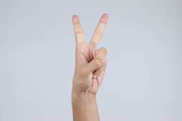 A hand that makes a gesture with a thumbs up shows a number two. Symbol of peace. (Clipping Path)