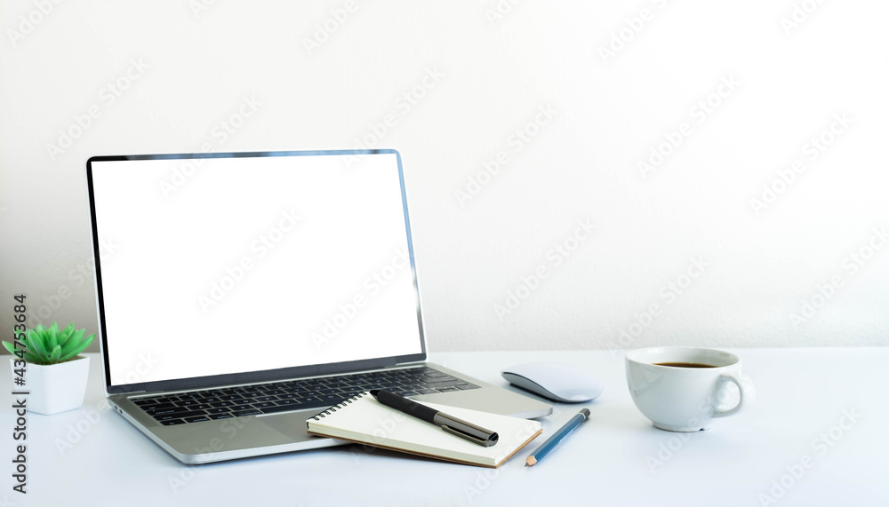Aufkleber laptop computer blank screen on white office desk table with coffee cup and notebook, mouse computer