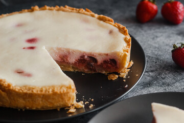 Delicious pie with strawberries and cream. Pie on the table. Pie with berries on a plate 