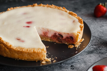 Delicious pie with strawberries and cream. Pie on the table. Pie with berries on a plate 