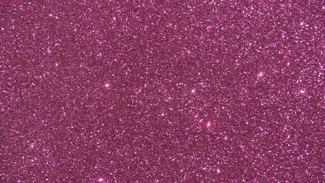 Festive glitter background. Pink glamorous sparkling and shining rotating background. Copy space