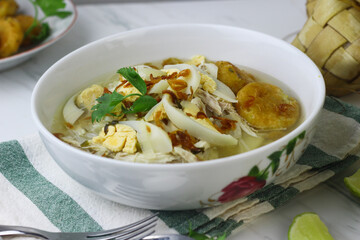 Soto Banjar, Indonesian traditional cuisine from South Kalimantan. The ingredients include ketupat, egg, chicken slices. Served with sambal and lime. Served on Idul adha and Idul Fitri celebration.