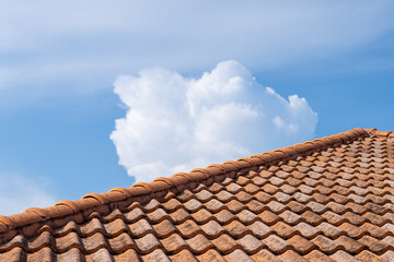 Close up of brown clay roof tiles. Red old dirty roof. Old roof tiles. Construction equipment build a house.
