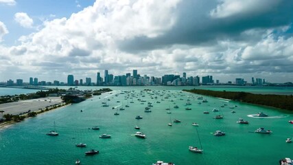 Aerial hyperlapse of Miami's skyline in 4k with boats moving. Downtown Brickell, Florida.