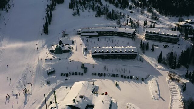 Aerial view around resorts and restaurants, in Olos, Lapland - orbit, drone shot