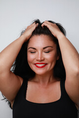 Fototapeta premium Portrait of pretty thoughtful woman with happy expression. Close-up portrait.