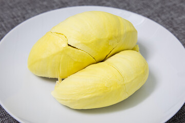 Pieces of Durian fruit on white dish.