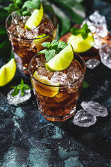 Cuba Libre with brown rum, cola, mint and lime. Cold Longdrink, alcohol cocktail.