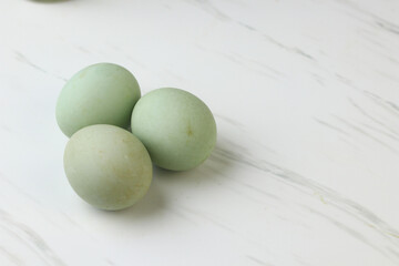 Telur bebek rebus or boiled duck eggs on ceramic bowl. White background, copy space for text. 
