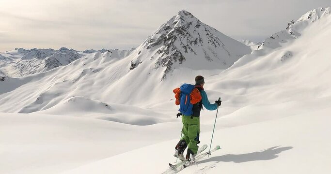 Ski touring with a professional guide offpist and backcountry in tyrol. Untracked snow and beautiful winter mountain landscape the perfect place for ski touring and enjoying freedome. 4K follow cam