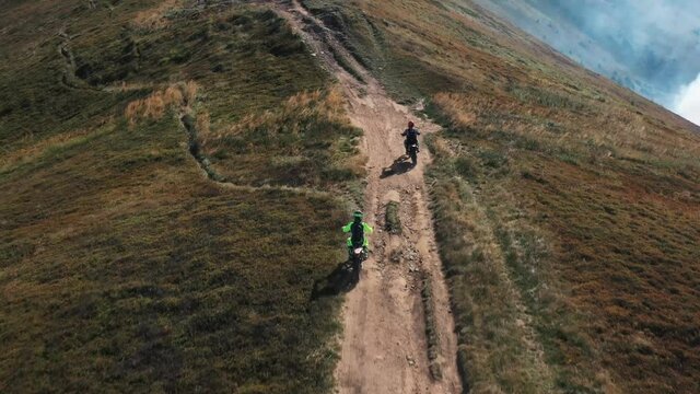 Aero shooting, moto endurists in the mountains, riding on the ridge. The motto of life. Training.