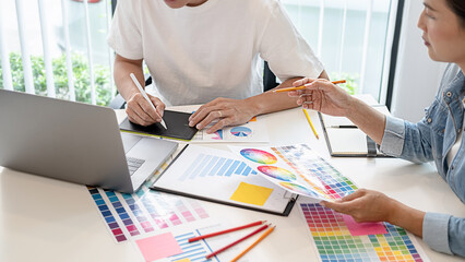 Graphic design and color swatches and pens on a desk. Architectural drawing with work tools and...