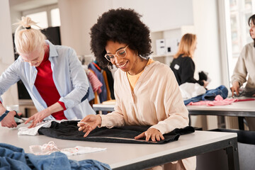 Woman looking attentively at the clothes and thinking how to redo